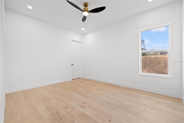 spare room featuring light hardwood / wood-style flooring and ceiling fan