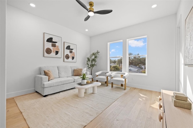 living room featuring light hardwood / wood-style flooring and ceiling fan