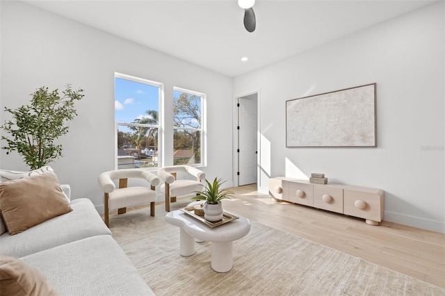 living room with ceiling fan and light hardwood / wood-style floors