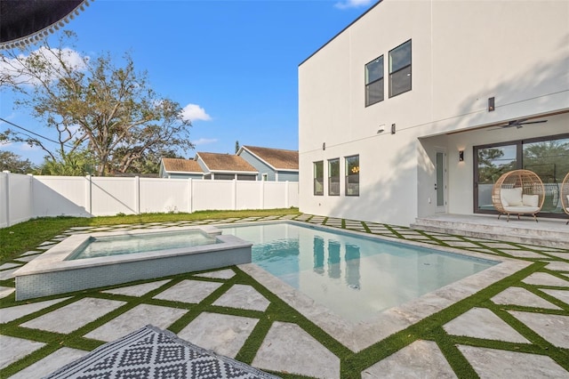 view of pool with an in ground hot tub, ceiling fan, and a patio