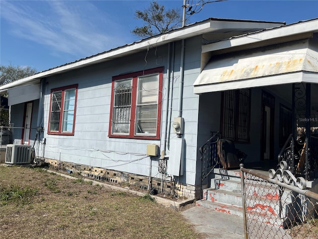 view of side of property featuring central AC