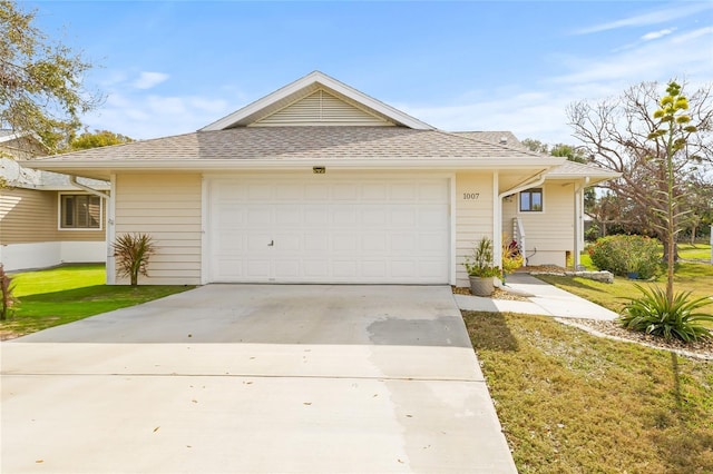1007 Lake Avoca Dr, Tarpon Springs, FL 34689 - ranch-style home with a garage and a front lawn