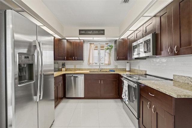 1007 Lake Avoca Dr, Tarpon Springs, FL 34689 - kitchen featuring appliances with stainless steel finishes, light stone countertops, sink, and backsplash