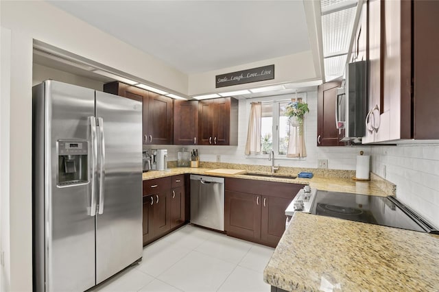 1007 Lake Avoca Dr, Tarpon Springs, FL 34689 - kitchen featuring light stone counters, sink, backsplash, and appliances with stainless steel finishes