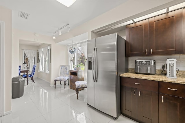 1007 Lake Avoca Dr, Tarpon Springs, FL 34689 - kitchen with tasteful backsplash, light stone counters, stainless steel refrigerator with ice dispenser, dark brown cabinets, and track lighting