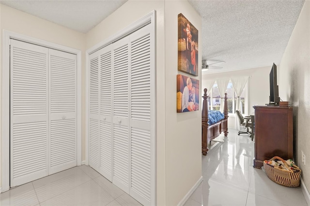 1007 Lake Avoca Dr, Tarpon Springs, FL 34689 - hallway featuring light tile patterned floors and a textured ceiling