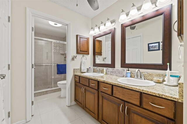 1007 Lake Avoca Dr, Tarpon Springs, FL 34689 - bathroom featuring vanity, an enclosed shower, a textured ceiling, and toilet