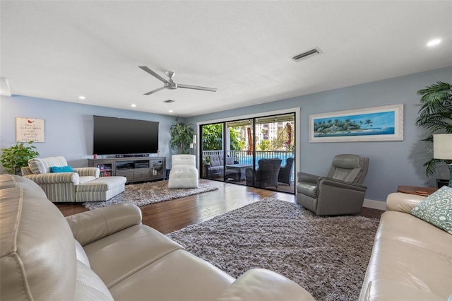 living room with ceiling fan and wood-type flooring