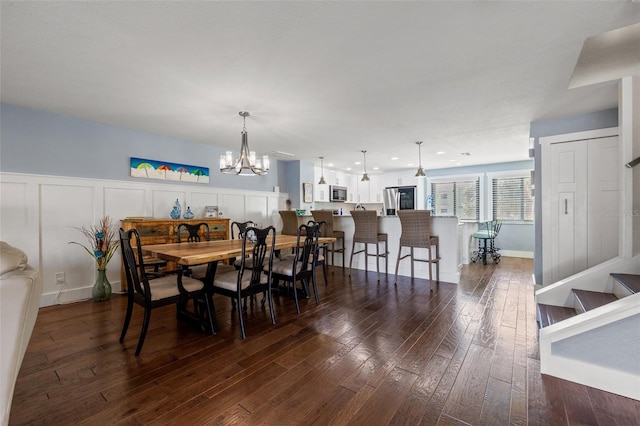 dining room featuring dark wood-type flooring and a chandelier