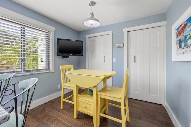 dining room with dark hardwood / wood-style flooring