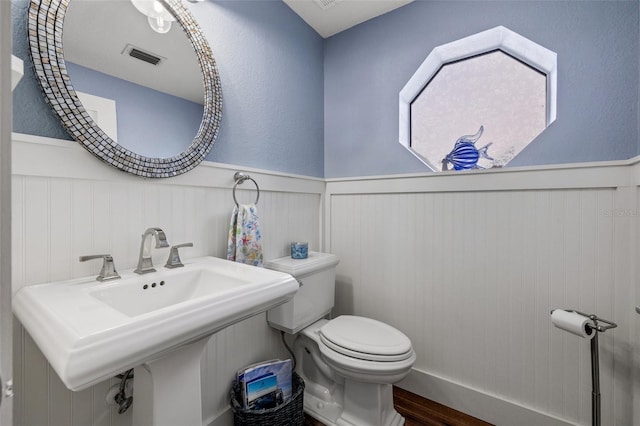 bathroom featuring hardwood / wood-style floors, sink, and toilet