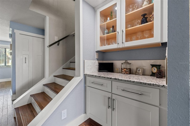 staircase with hardwood / wood-style floors