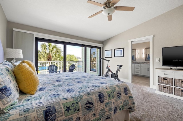 carpeted bedroom featuring ceiling fan, vaulted ceiling, connected bathroom, a textured ceiling, and access to outside