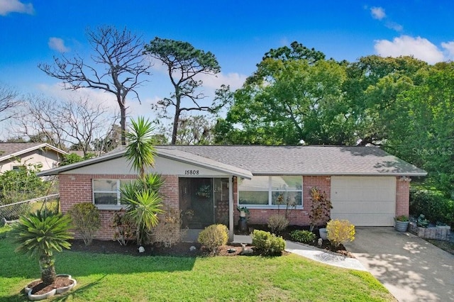 ranch-style home featuring a garage, a front lawn, concrete driveway, and brick siding