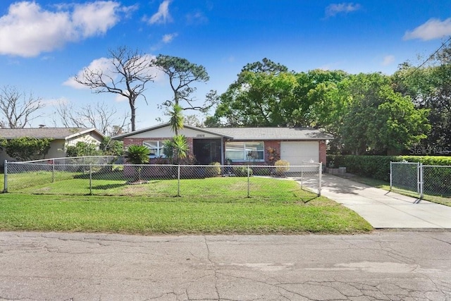 view of front of property with a fenced front yard, concrete driveway, and a front yard