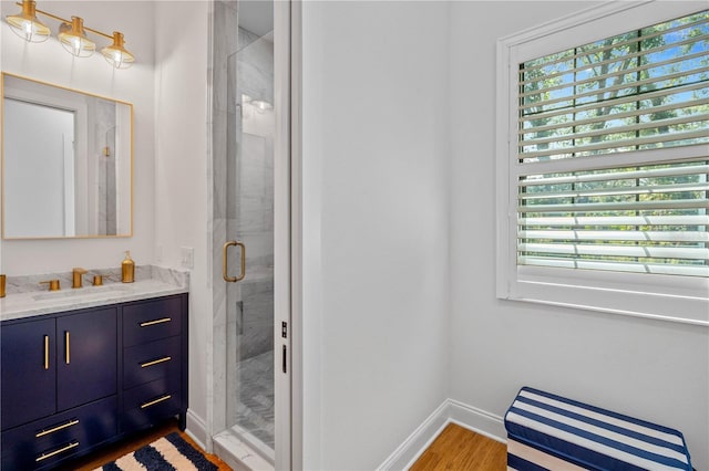 bathroom featuring vanity, an enclosed shower, and hardwood / wood-style floors