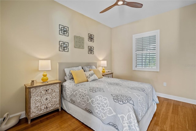 bedroom featuring hardwood / wood-style floors and ceiling fan