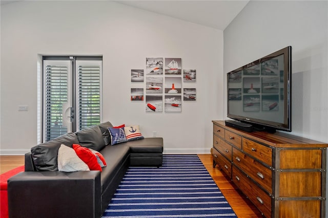 living room featuring hardwood / wood-style flooring and lofted ceiling