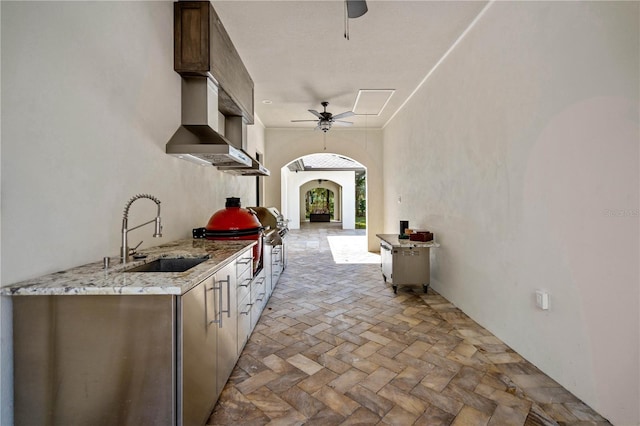 view of patio / terrace featuring sink, ceiling fan, and exterior kitchen