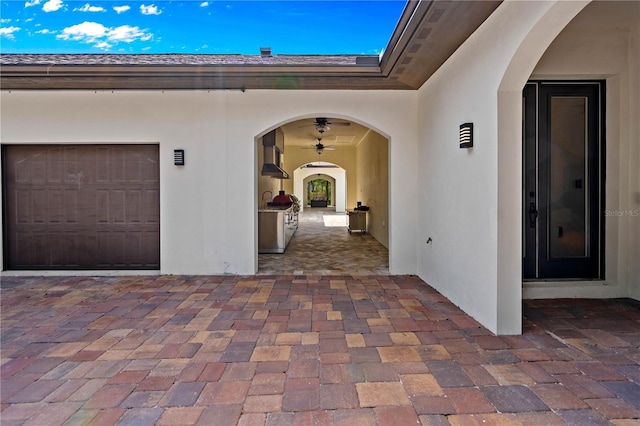 exterior space with an outdoor kitchen and a garage