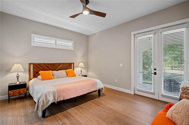 bedroom featuring wood-type flooring, access to outside, ceiling fan, and french doors