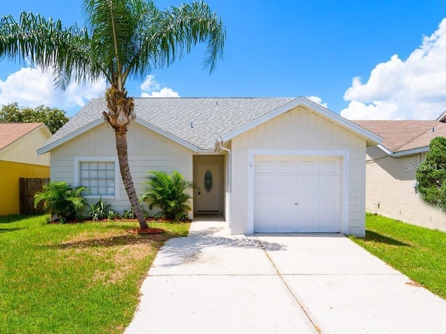 ranch-style house featuring a garage and a front yard