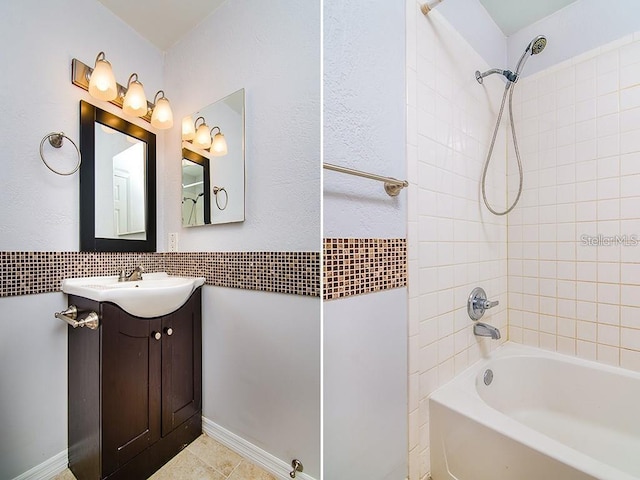 bathroom featuring vanity and tiled shower / bath