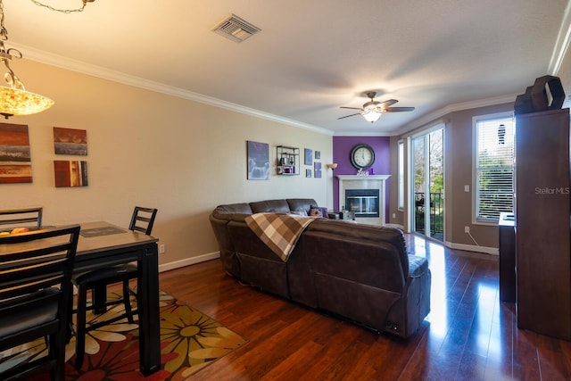 102 Brent Cir, Oldsmar, FL 34677 - living area with ceiling fan, dark wood finished floors, crown molding, baseboards, and a glass covered fireplace