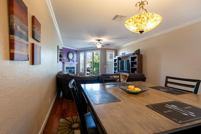 102 Brent Cir, Oldsmar, FL 34677 - dining space with crown molding, wood finished floors, baseboards, a textured wall, and a ceiling fan