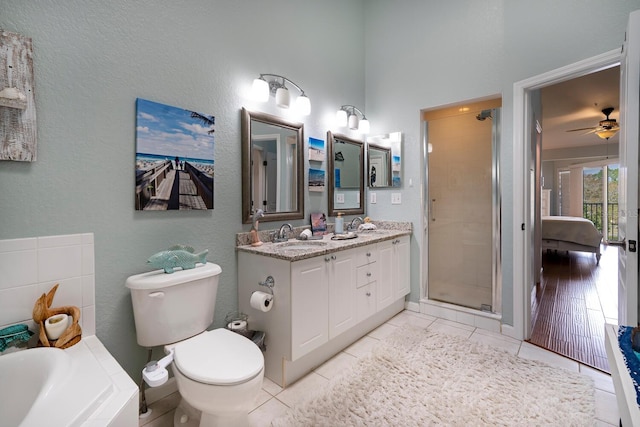 102 Brent Cir, Oldsmar, FL 34677 - ensuite bathroom featuring double vanity, a stall shower, toilet, a bath, and tile patterned flooring