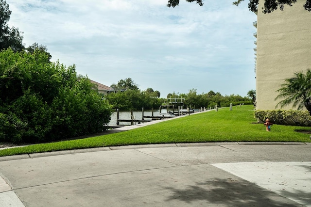102 Brent Cir, Oldsmar, FL 34677 - surrounding community with a boat dock, a yard, a water view, and boat lift