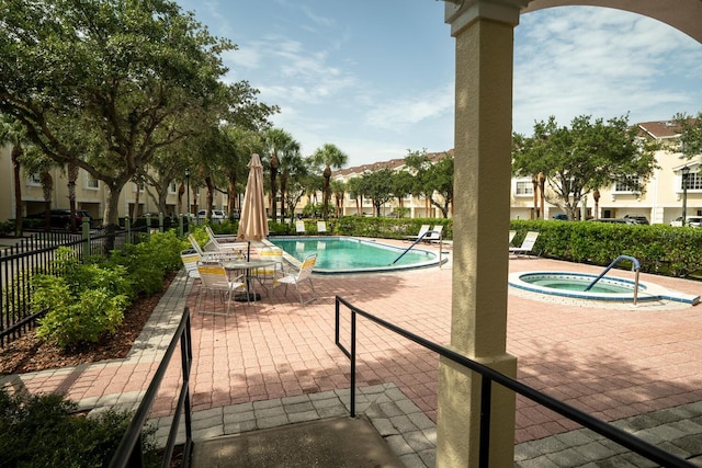 102 Brent Cir, Oldsmar, FL 34677 - community pool featuring a hot tub and a patio area