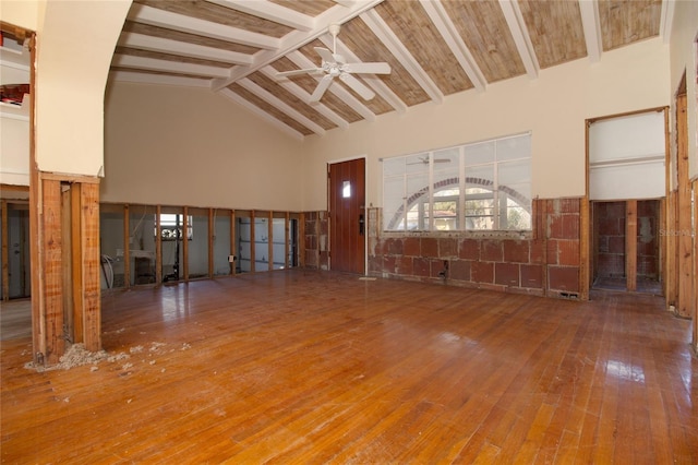 interior space with hardwood / wood-style floors, beam ceiling, high vaulted ceiling, and ceiling fan