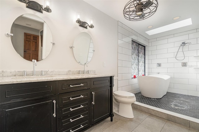 full bathroom with vanity, tile patterned floors, toilet, and separate shower and tub