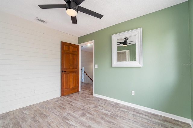 empty room featuring ceiling fan and light wood-type flooring