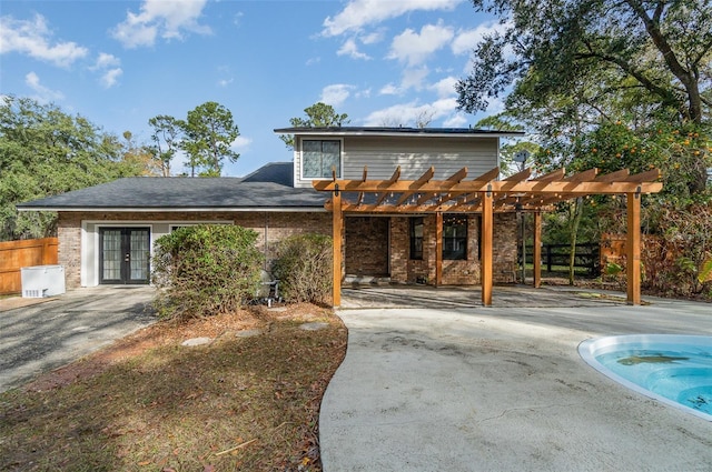 view of front facade featuring a pergola and french doors