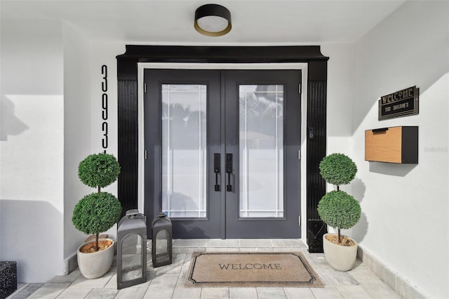 view of exterior entry featuring french doors