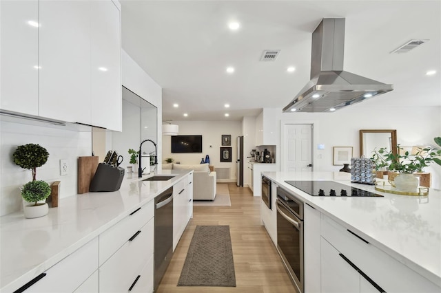 kitchen featuring white cabinetry, appliances with stainless steel finishes, sink, and island range hood