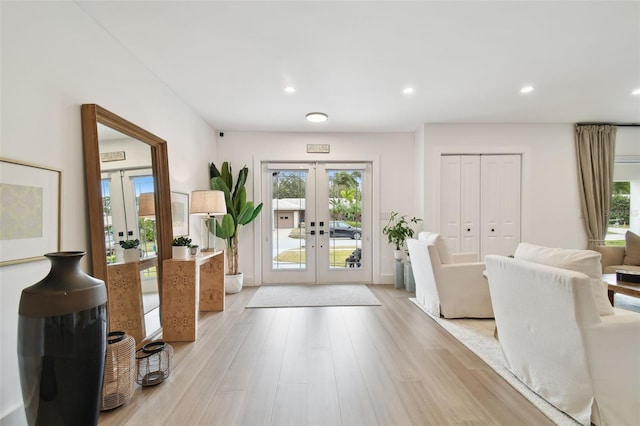 doorway to outside with french doors, a healthy amount of sunlight, and light hardwood / wood-style flooring