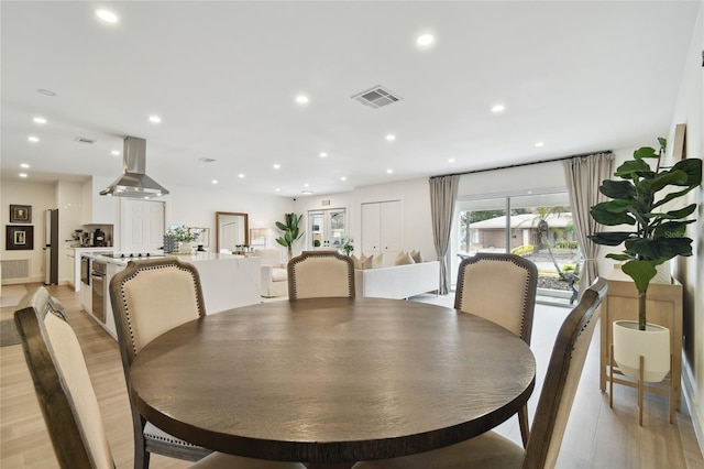 dining space with light wood-type flooring