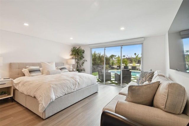 bedroom with access to outside and light hardwood / wood-style flooring