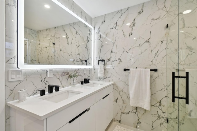 bathroom featuring vanity and a shower with door