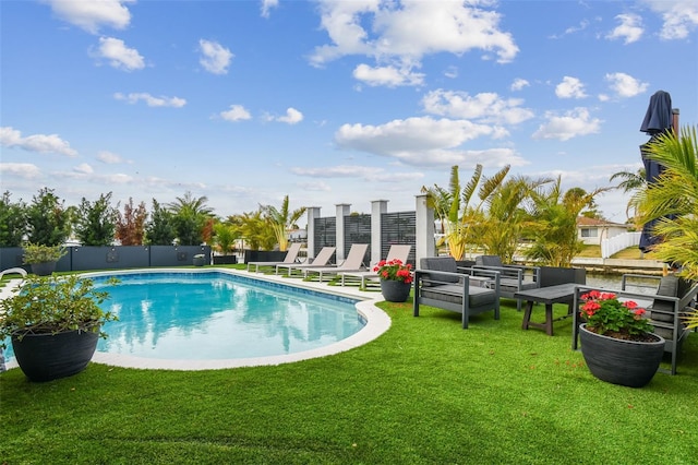 view of swimming pool with a lawn