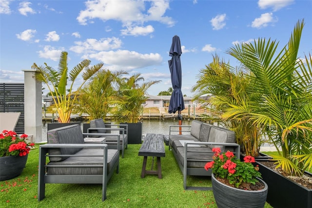 view of yard with an outdoor living space and a water view