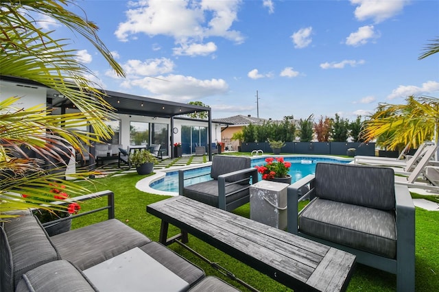 view of swimming pool with an outdoor living space, a patio, and a lawn