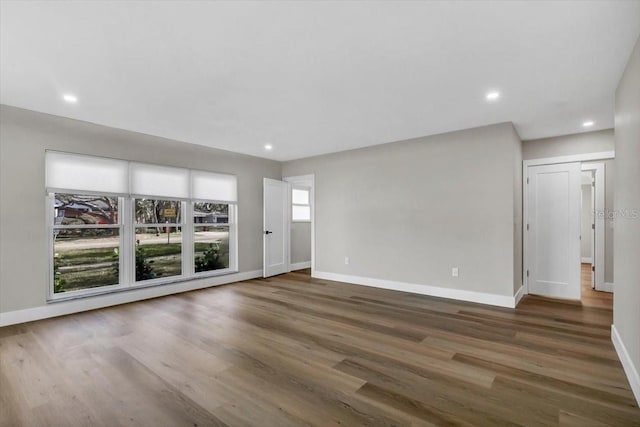 unfurnished living room featuring dark hardwood / wood-style floors