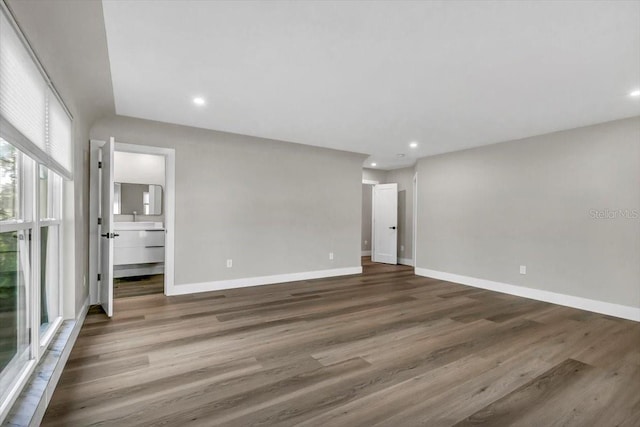 unfurnished room with dark hardwood / wood-style flooring