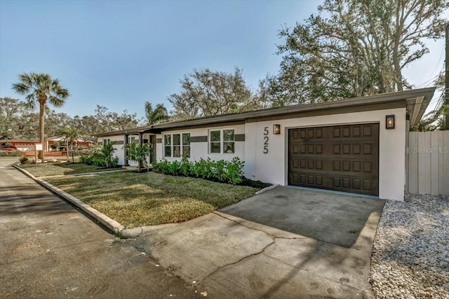 ranch-style home featuring a garage and a front yard