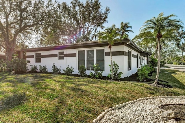 view of home's exterior with a lawn