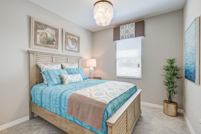 tiled bedroom with an inviting chandelier